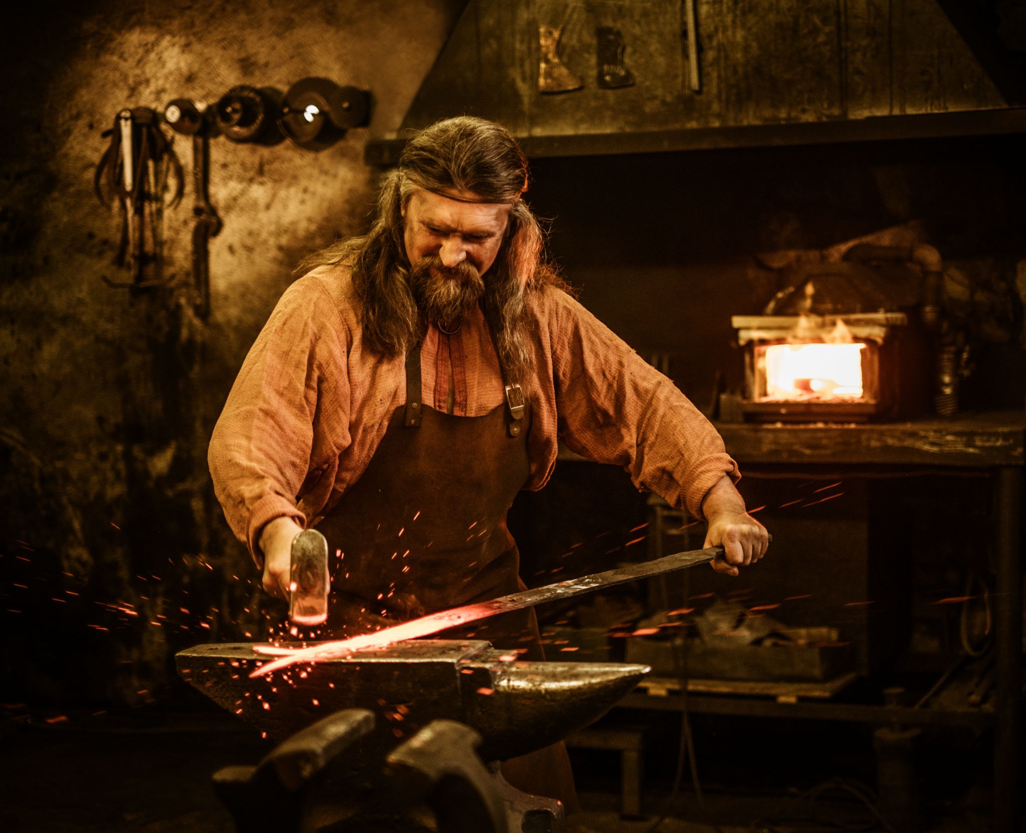 Senior blacksmith forging the molten metal
